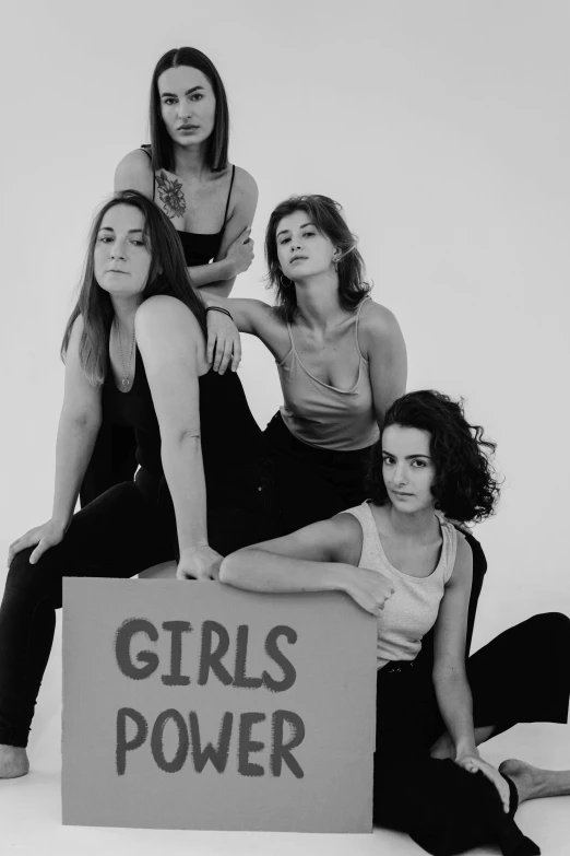 a group of women sitting on top of a box, an album cover, inspired by Nan Goldin, cg society, feminist art, grainy black-and-white photo, (beautiful) girl, gilmore girls aesthetic, 15081959 21121991 01012000 4k