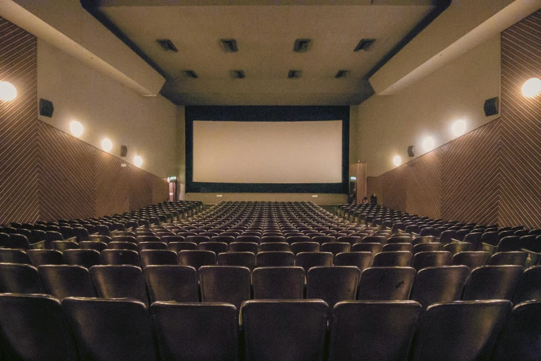 a large auditorium with rows of seats and a projector screen, a picture, unsplash, art nouveau, blockbuster movie, felix kelly, 2 0 0 0's photo, multiple stories
