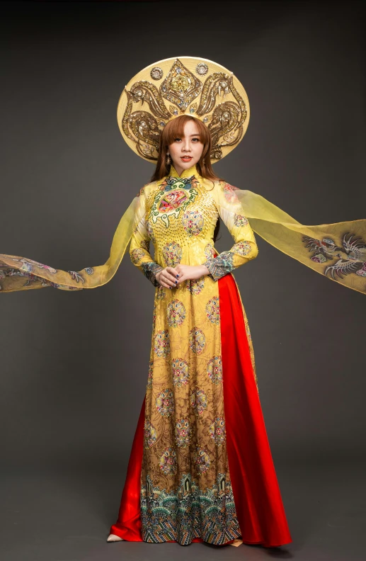 a woman in a yellow and red dress and hat, an album cover, inspired by Tang Di, ao dai, ornate cosplay, slide show, religious