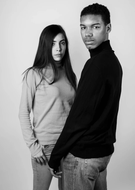 a man and a woman standing next to each other, a black and white photo, inspired by Richard Avedon, wearing turtleneck, aida muluneh, studio shoot, androgynous male