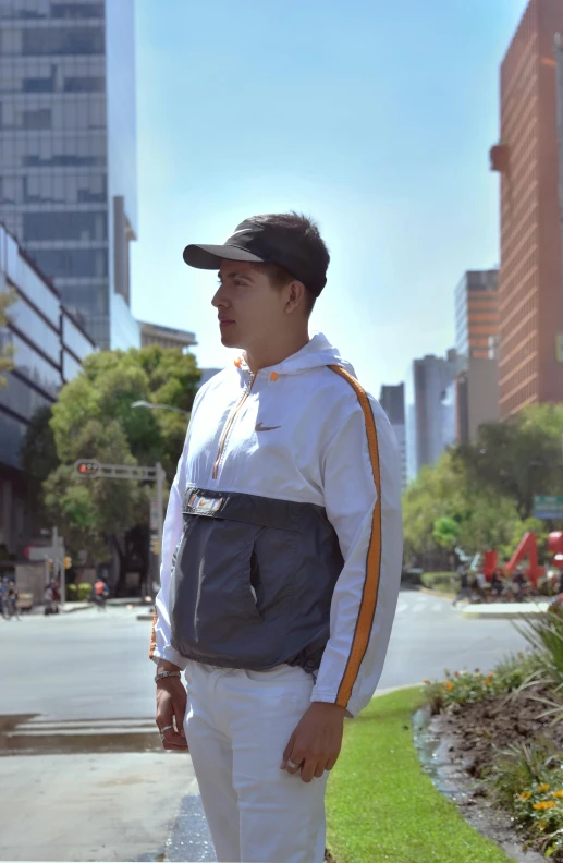 a man standing on a sidewalk in a city, by Alejandro Obregón, wearing a track suit, orange grey white, avatar image, mexico city