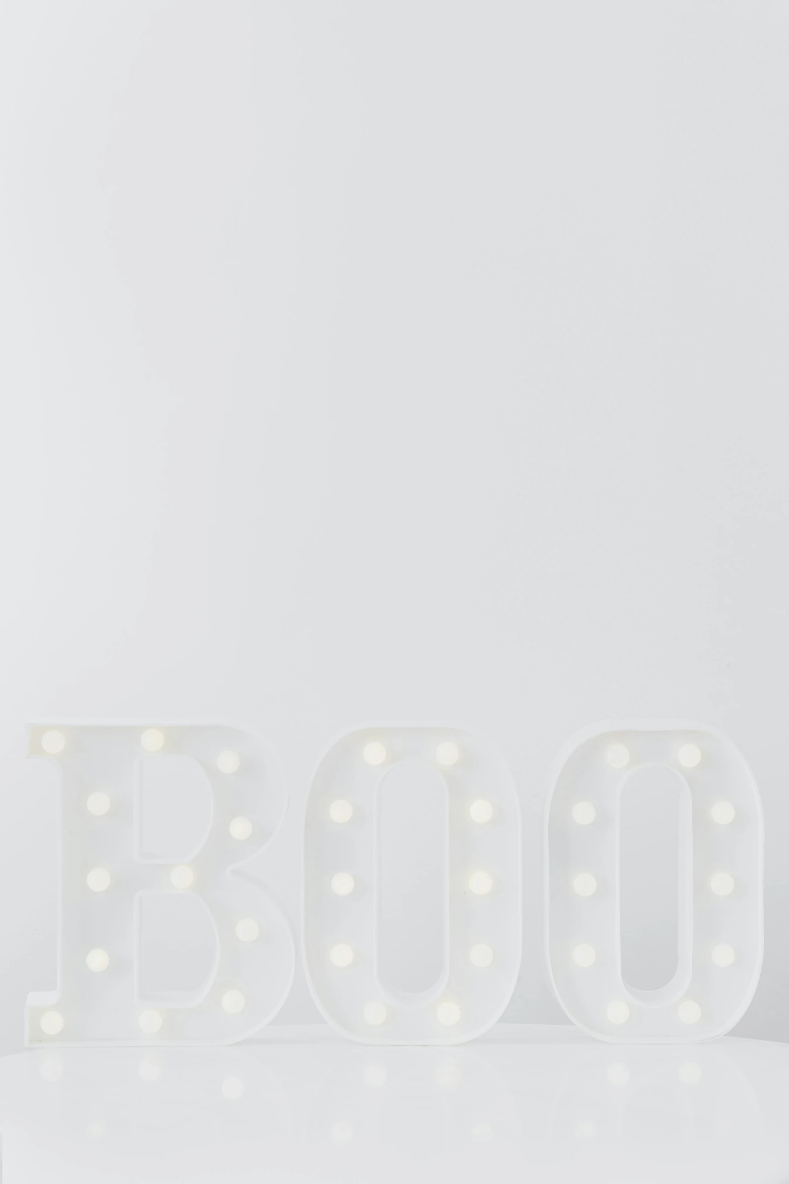 a couple of white letters sitting on top of a table, in a halloween style, product image, bounce light, on clear background