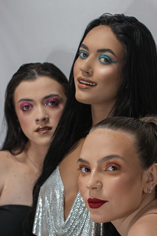 a group of women standing next to each other, an album cover, by John Luke, renaissance, creative colorfull - makeup, detail shot, in colour, iridescent eyes