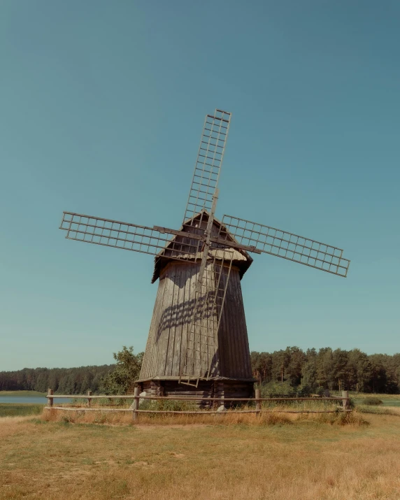 a windmill in a field next to a body of water, an album cover, by Attila Meszlenyi, pexels contest winner, hurufiyya, 15081959 21121991 01012000 4k, near forest, museum quality photo, having a good time