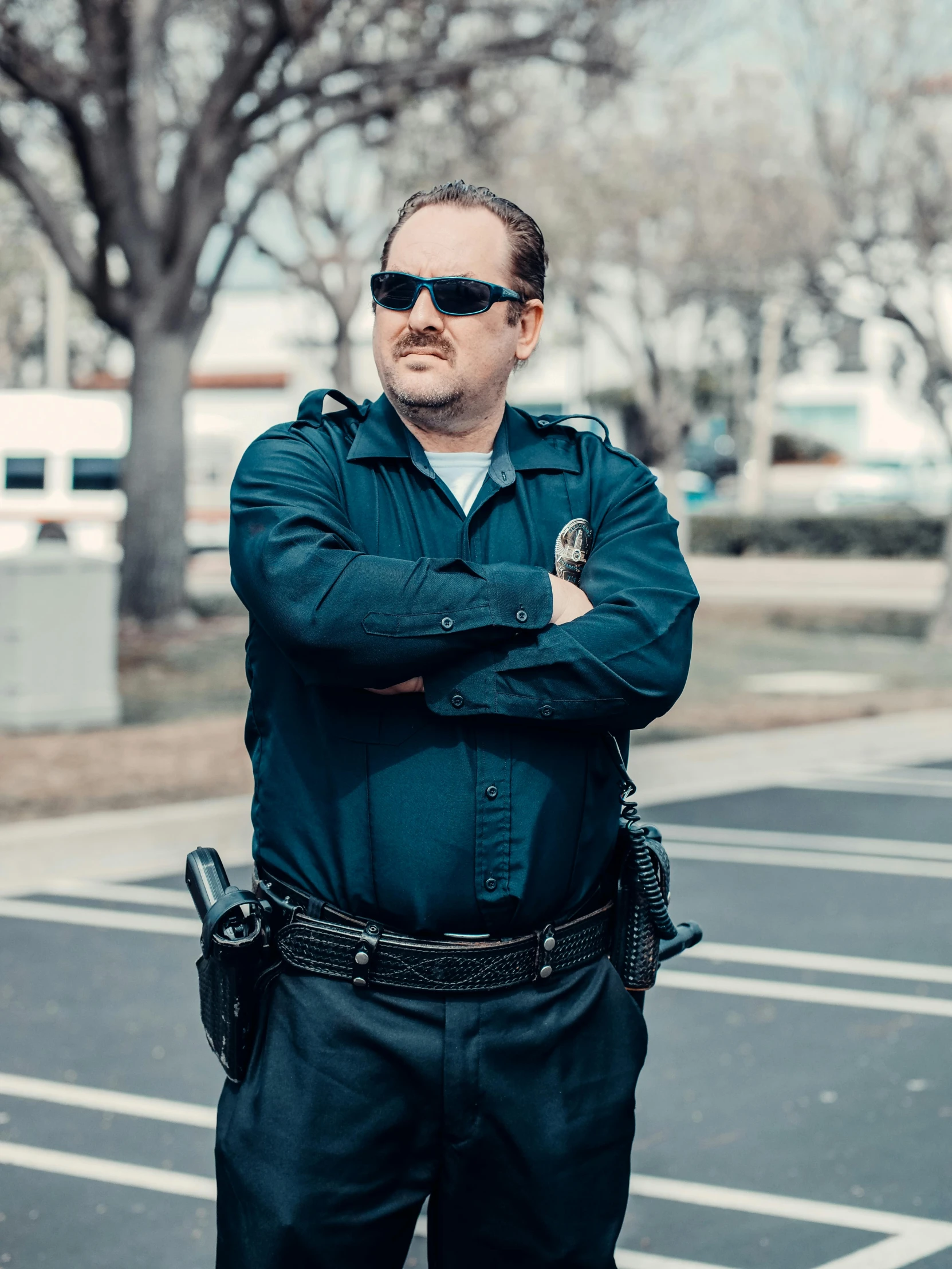 a man in a police uniform standing in a parking lot, a portrait, unsplash, renaissance, ricky berwick, thicc, bandoliers, low quality photo