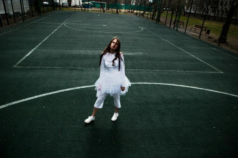 a woman in a white dress standing on a tennis court, an album cover, inspired by Elsa Bleda, pexels contest winner, antipodeans, wearing space techwear, playground, on a football field, yulia nevskaya