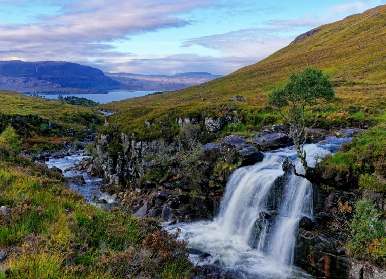 a small waterfall flowing through a lush green valley, by Jesper Knudsen, pexels contest winner, hurufiyya, skye meaker, avatar image, late summer evening, thumbnail