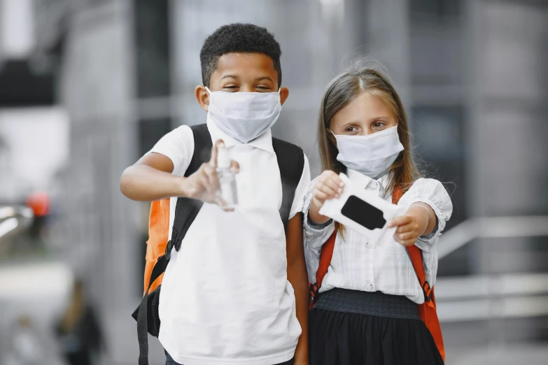 a couple of kids standing next to each other, a picture, shutterstock, medical mask, school, instagram picture, 15081959 21121991 01012000 4k