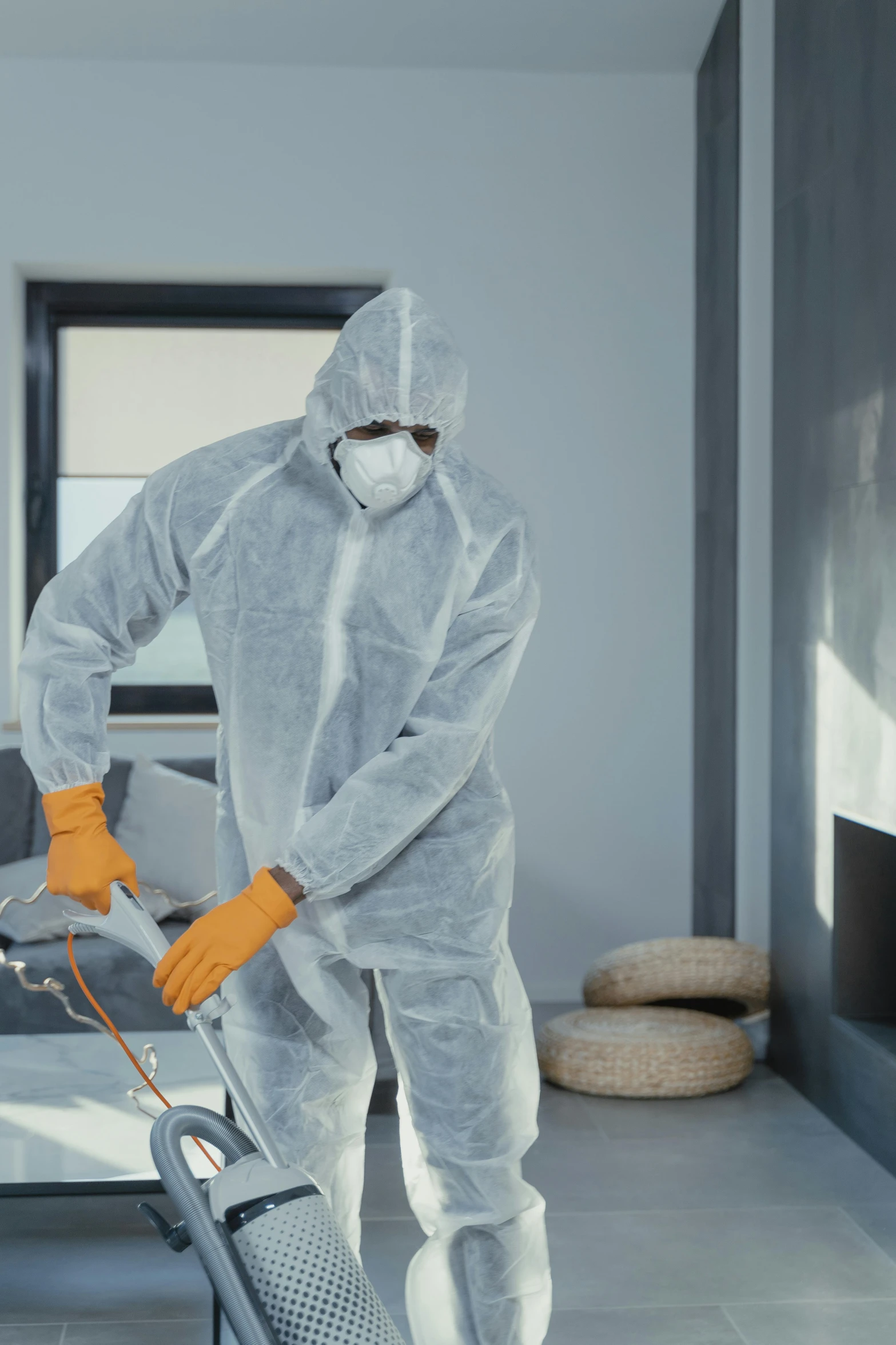 a man in a hazmat suit cleaning a living room, plasticien, grey, profile image, decorative, foam