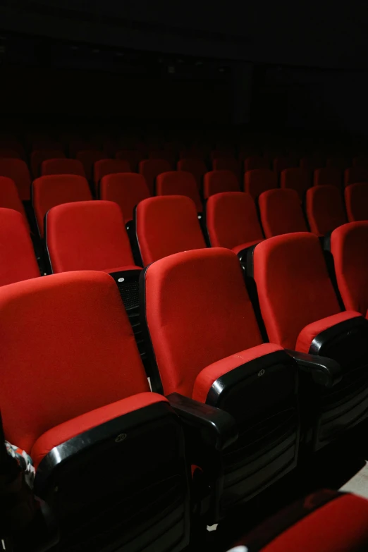 a row of red chairs in a dark room, imdb, photograph credit: ap, square, sports photo