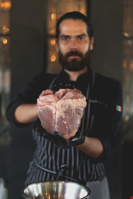 a man holding a piece of meat in a bowl, profile image, gotic harts, instagram photo, chefs table