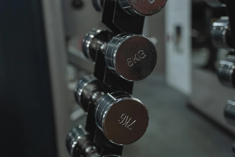 a close up of a rack of dumbs in a gym, by Emma Andijewska, unsplash, private press, chrome accents, bells, instagram picture, thumbnail