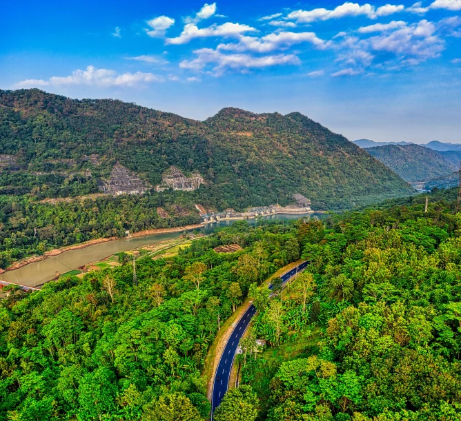 a river running through a lush green valley, by Joseph Severn, pexels contest winner, hurufiyya, guwahati, road between hills, thumbnail, ultra wide angle isometric view