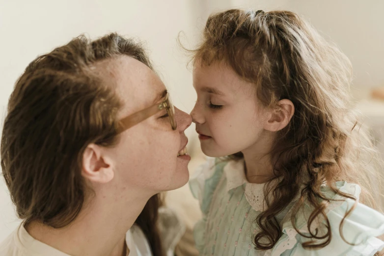 a woman kissing a little girl on the cheek, pexels contest winner, hyperrealism, brown, pokimane, profile image, indoor picture