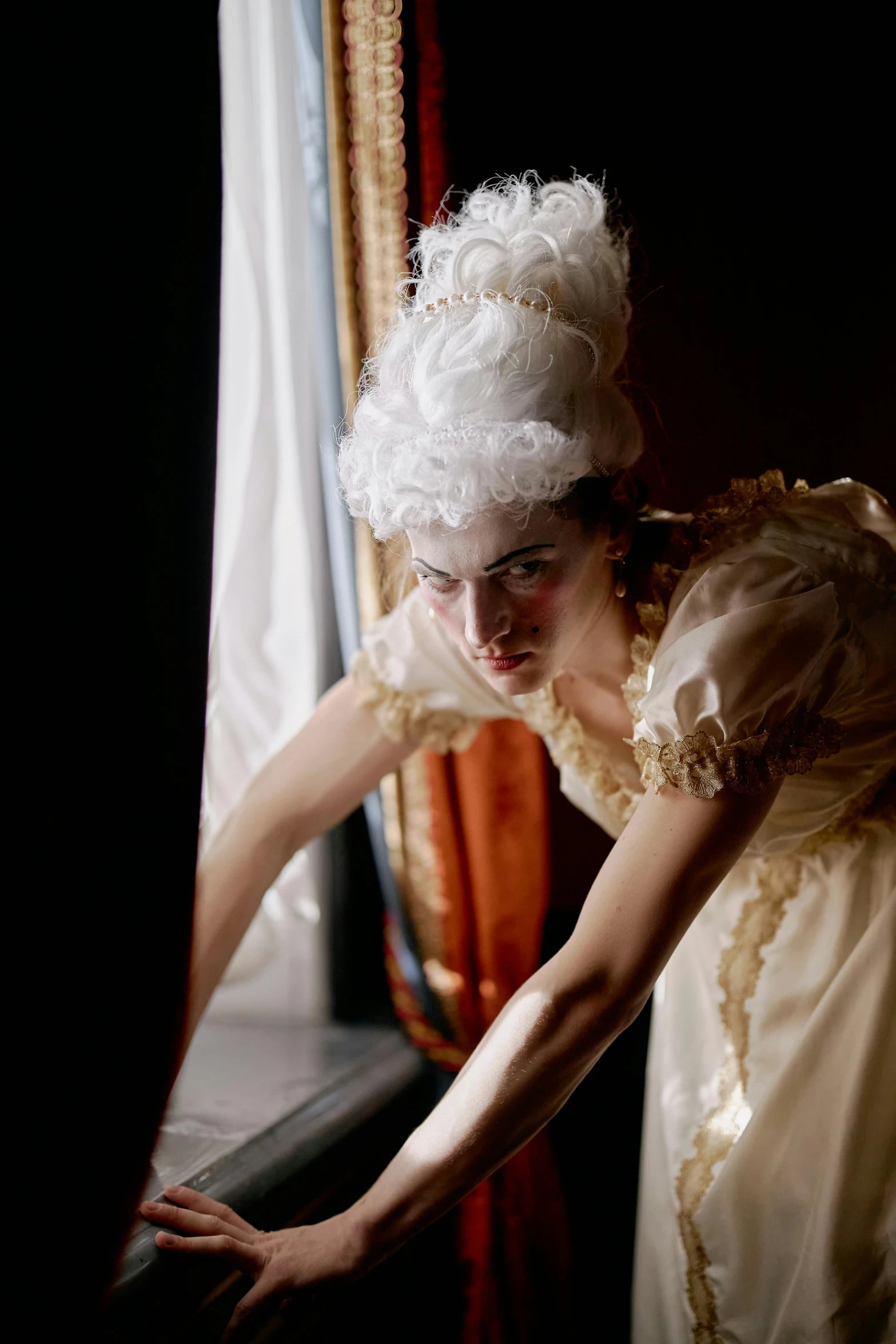 a woman in a white dress leaning on a window sill, inspired by Pietro Longhi, rococo, vhs footage still, angry at mirror, production photo, [ theatrical ]