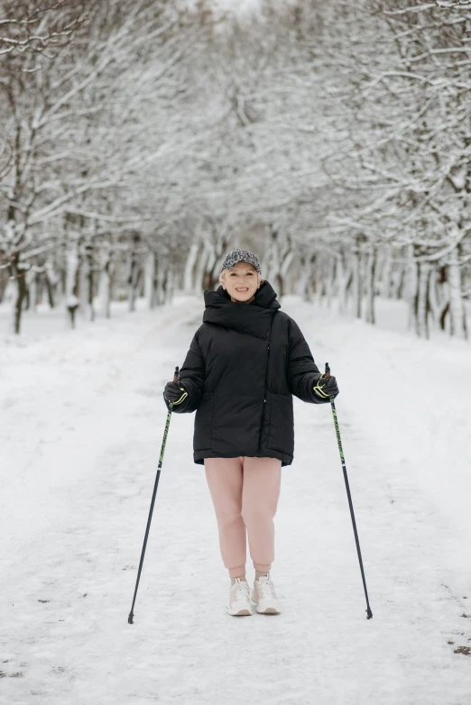 a woman riding skis down a snow covered slope, a portrait, by Julia Pishtar, pexels contest winner, renaissance, walking at the park, 🎀 🧟 🍓 🧚, in russia, grey