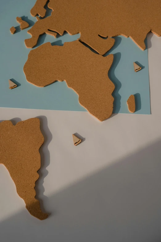 a map of the world cut out of cardboard, trending on unsplash, conceptual art, half african, multiple stories, grain”, graphic”