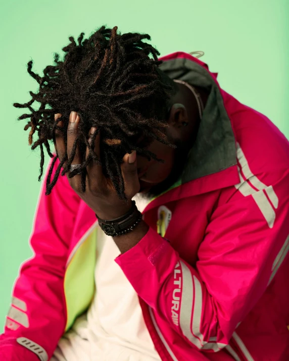 a man with dreadlocks sitting on a chair, an album cover, trending on pexels, hurufiyya, dayglo pink, facepalm, model wears a puffer jacket, thicc