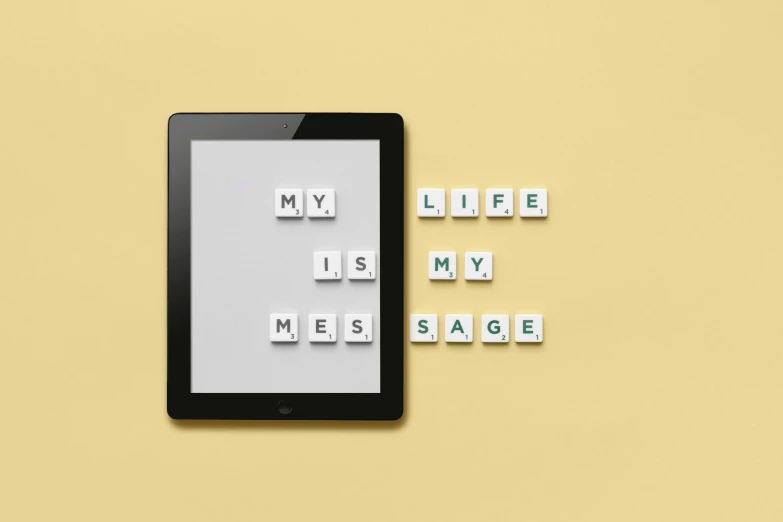 a tablet computer sitting on top of a table, an album cover, inspired by Edward Ruscha, unsplash, letterism, help me, style game square enix life, setting is bliss wallpaper, sage