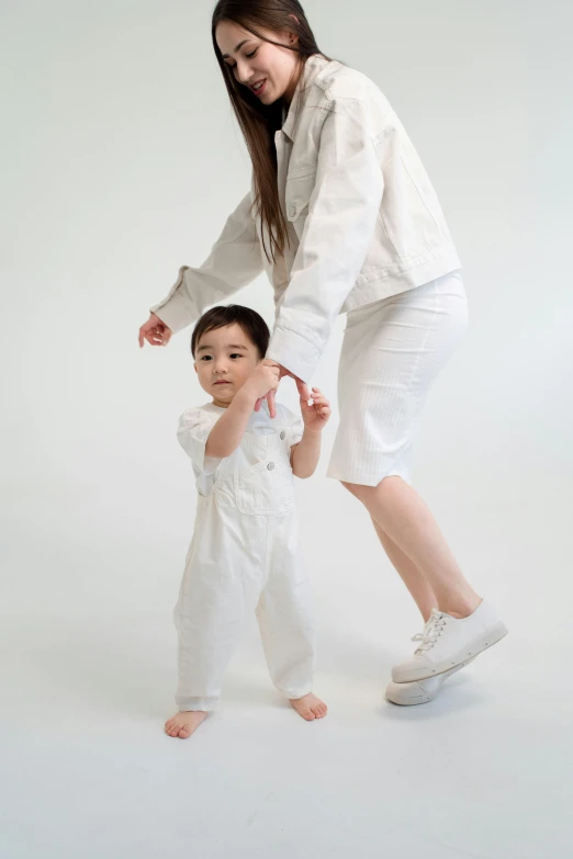 a woman standing next to a small child, by Ellen Gallagher, unsplash, dada, wearing white pajamas, longque chen, bouncing, wearing off - white style