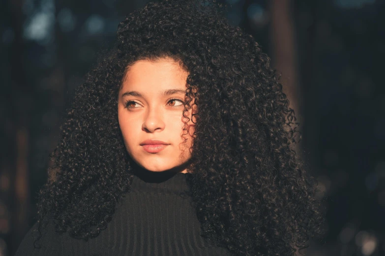 a close up of a woman with curly hair, pexels contest winner, girl with black hair, ariel perez, jamie reid, slightly smooth