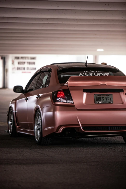 a car is parked in a parking garage, inspired by An Gyeon, reddit, brushed rose gold car paint, centered full body rear-shot, subaru, physical : tinyest midriff ever