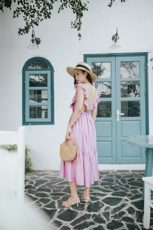 a woman in a pink dress and straw hat standing in front of a blue door, by Miyamoto, unsplash, open back dress, cottagecore!! fitness body, full body cute young lady, square