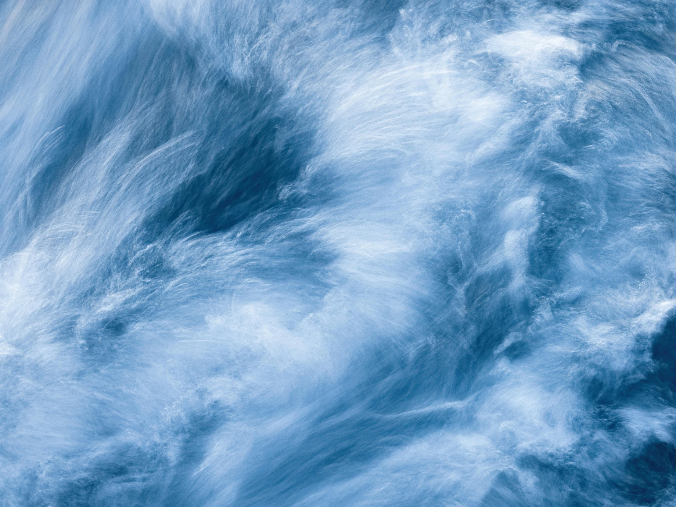 a close up of a body of water with waves, an album cover, inspired by George Frederic Watts, trending on unsplash, lyrical abstraction, blue fur, cloud nebula, feathery fluff, low angle 8k hd nature photo