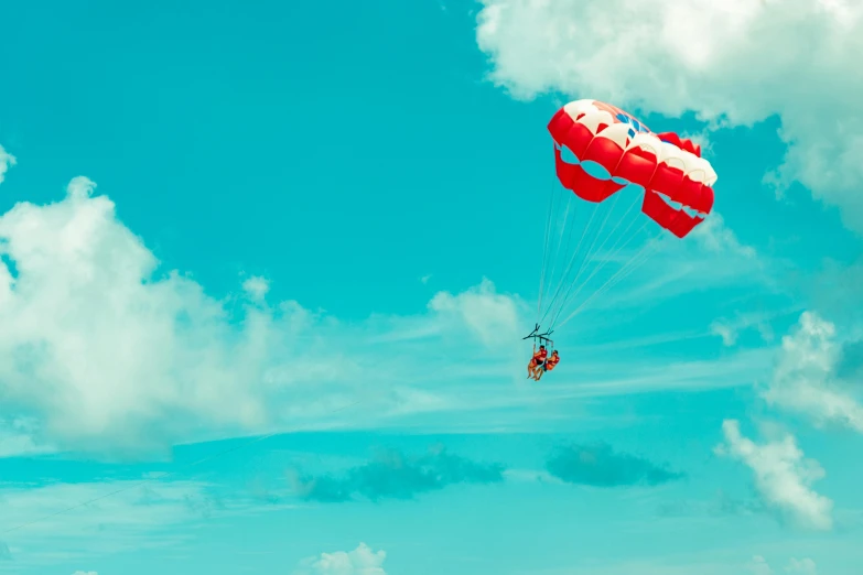 a person parasailing in the sky on a sunny day, by Julia Pishtar, pexels contest winner, pop art, red and cyan theme, slide show, upon the clouds, clemens ascher