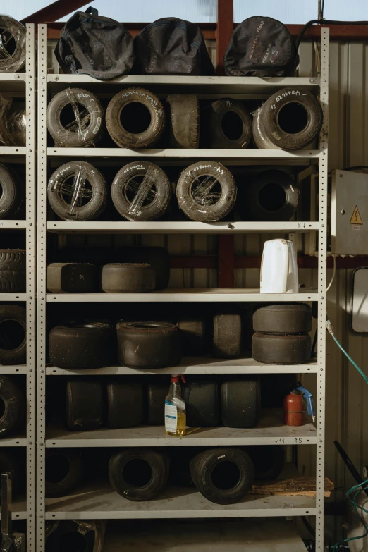 a garage filled with lots of different types of tires, a portrait, by David Simpson, f 1.4 kodak portra, shelf, dust, in an underground laboratory