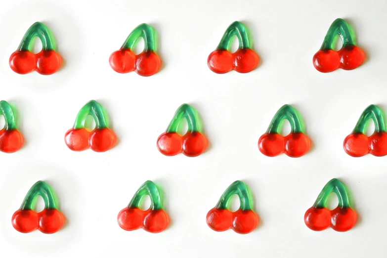 a bunch of cherries sitting on top of a white surface, fusing, made out of glass, | 28mm |, inflateble shapes