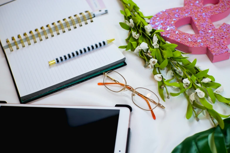 a tablet computer sitting on top of a white table, a picture, trending on pexels, academic art, pink glasses, plants in glasses, dressed in ornate, romantic lead