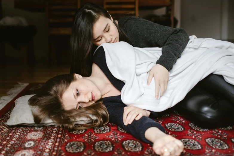 a woman and a young girl laying on a rug, by Julia Pishtar, trending on pexels, hurufiyya, in pain, lesbian, man grabbing a womans waist, profile image