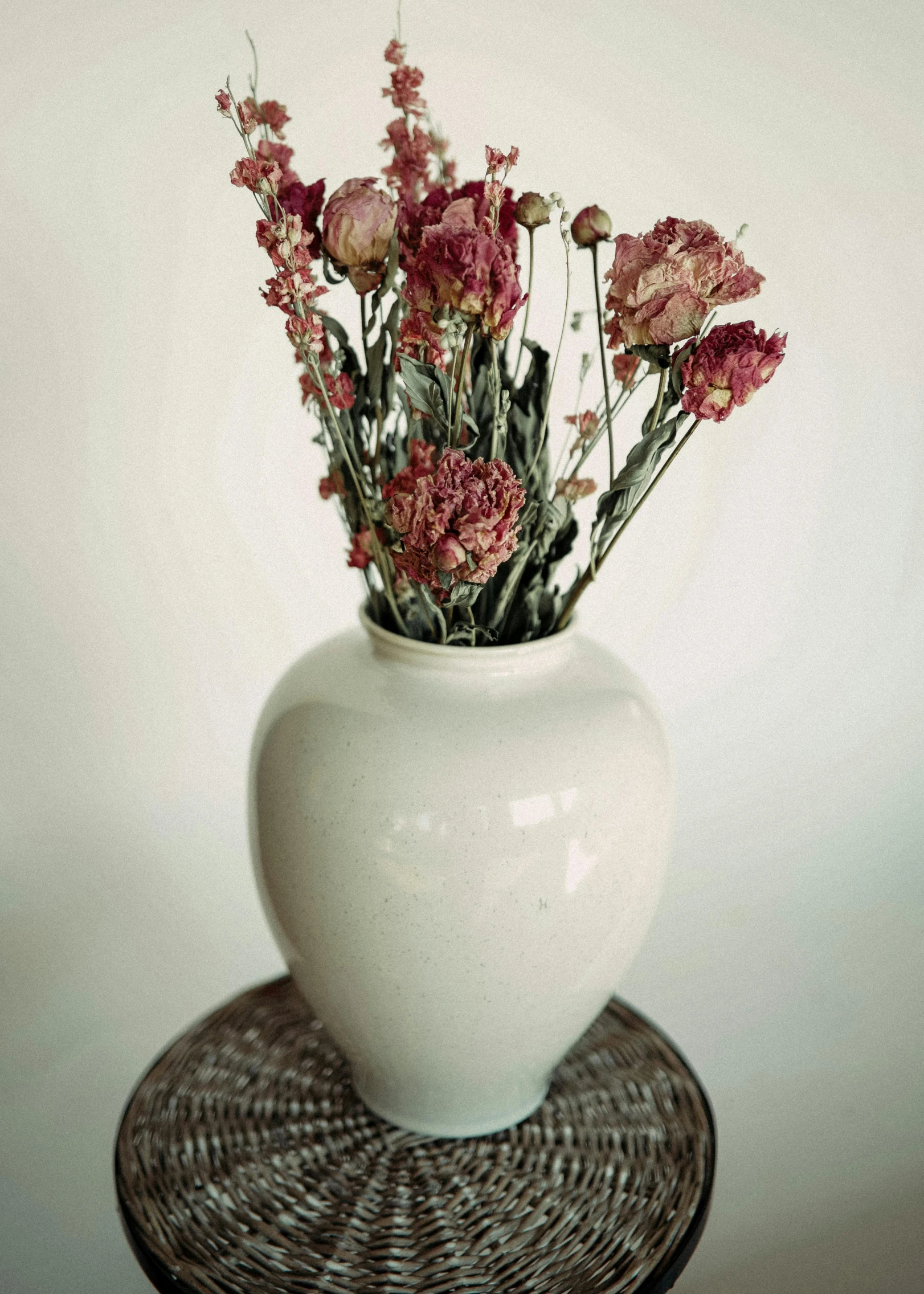 a white vase with some pink flowers in it, inspired by François Boquet, unsplash, dried flowers, made of glazed, soft vintage glow, very large