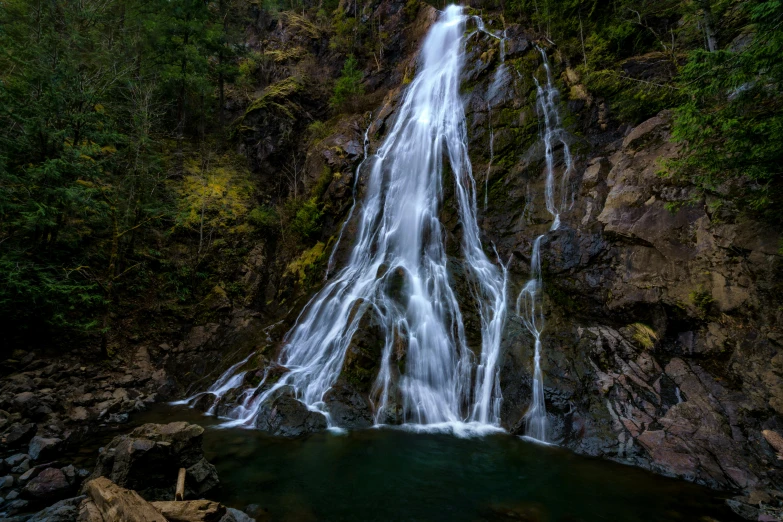 a waterfall in the middle of a forest, pexels contest winner, hurufiyya, british columbia, thumbnail, 8 k hi - res, tall thin