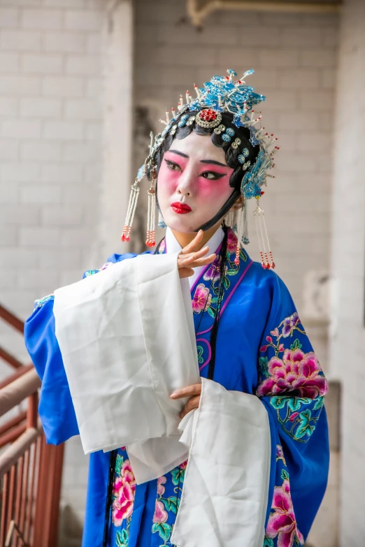 a woman dressed as a geisha holding a piece of paper, an album cover, inspired by Xie Huan, trending on unsplash, visual art, square, peking opera, wearing blue robe, slide show