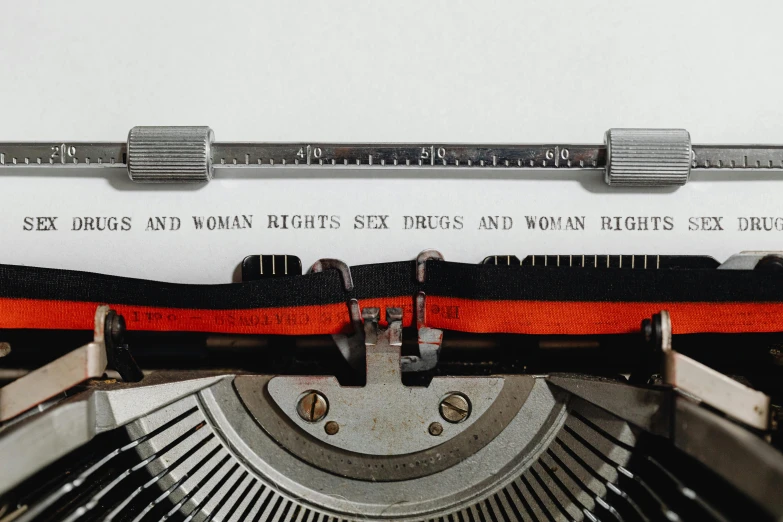 a close up of an old typewriter, an album cover, by Adam Marczyński, pexels contest winner, queer woman, white and orange breastplate, scientific paper, crimes