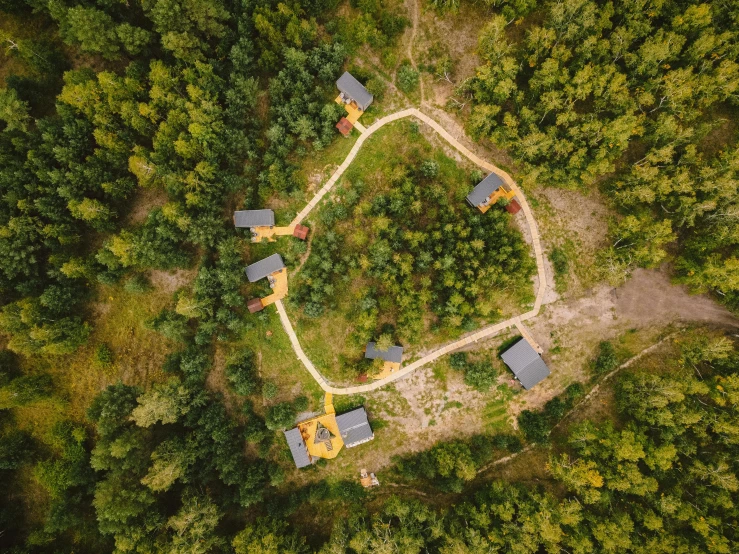 a small house in the middle of a forest, by Adam Marczyński, pexels contest winner, land art, top angle view, several cottages, glamping, shot on sony a 7 iii