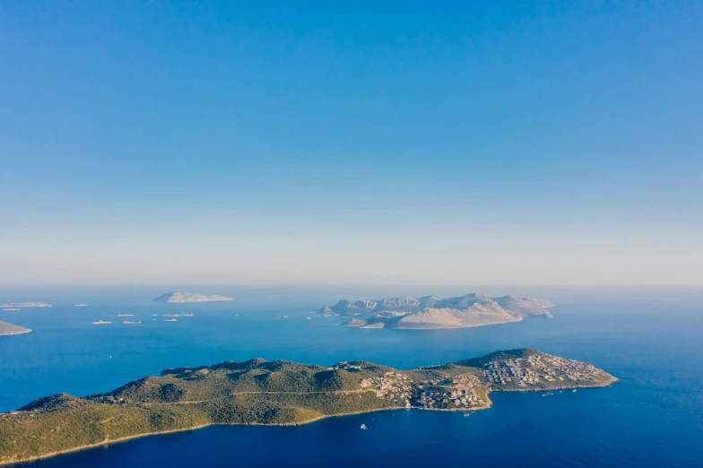 an island in the middle of a body of water, pexels contest winner, croatian coastline, “ aerial view of a mountain, islands on horizon, slim aarons