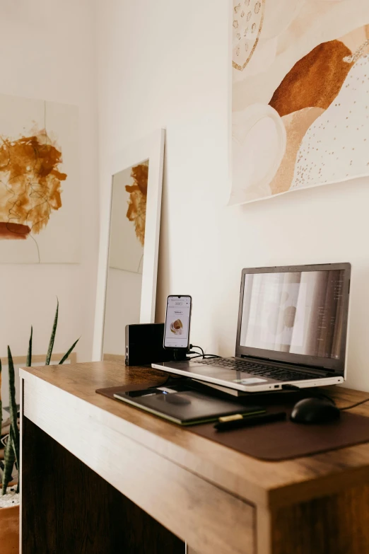 a laptop computer sitting on top of a wooden desk, by Carey Morris, trending on pexels, an interior of room, dwell, brown, conecpt art