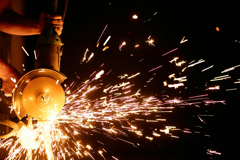 a person using a grinder on a fire hydrant, by Matt Stewart, unsplash, welding torches for arms, avatar image, steel plating, holding a giant flail