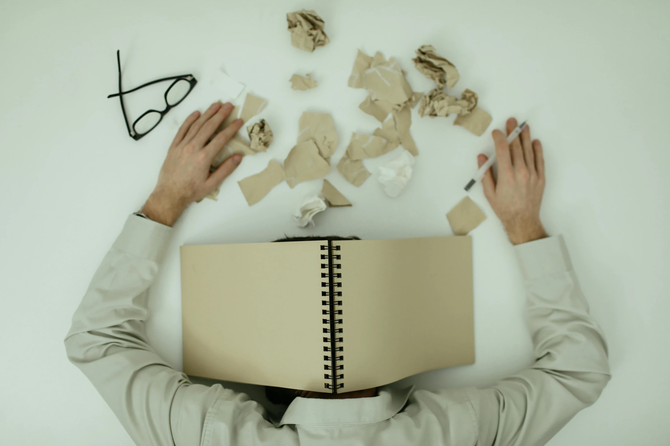 a person that is holding a book over their head, pexels contest winner, analytical art, lying scattered across an empty, screenwriter, plain background, brown paper