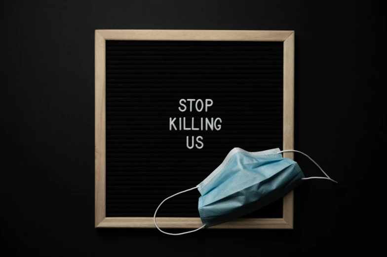 a sign that says stop killing us with a mask on it, a picture, trending on pexels, 8k cleaning future, death, blackboard, disturbing biohorror saliva