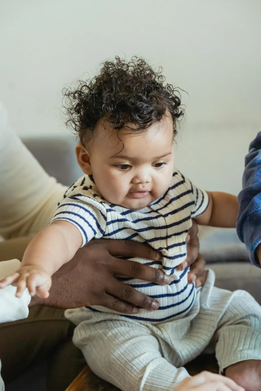 a close up of a person holding a baby, varying ethnicities, diagnostics, bouncy belly, little kid