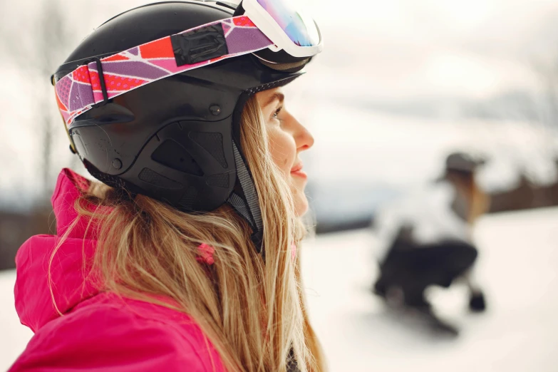 a woman riding a snowboard down a snow covered slope, pexels contest winner, private press, close up head shot, helmets, pink, contemplating