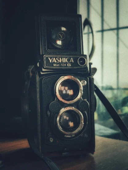 an old camera sitting on top of a wooden table, unsplash contest winner, visual art, yashica me - 1, medium format. soft light, 4k museum photograph, rolleiflex tlr