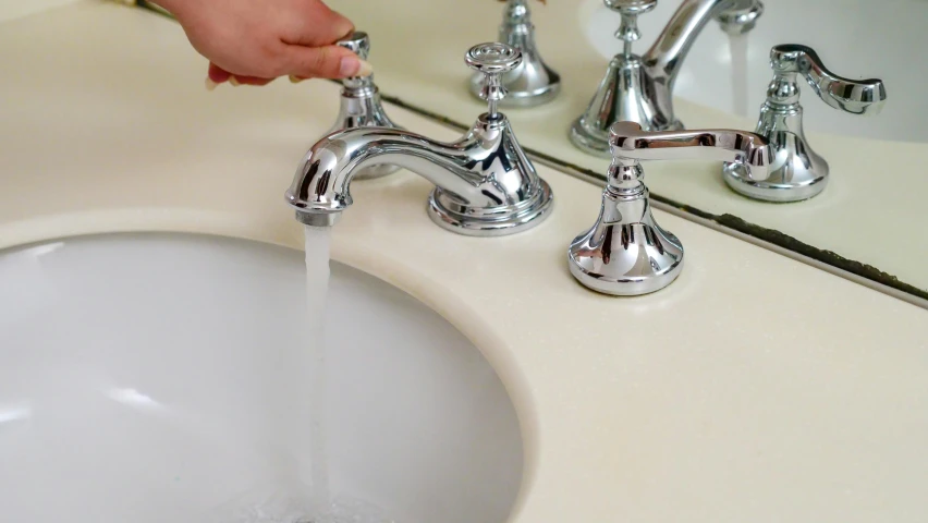 a person is washing their hands under a faucet, by Pamela Drew, pexels, fan favorite, different sizes, upscaled to high resolution, panels