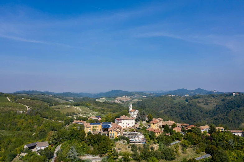 an aerial view of a small town in the mountains, a portrait, by Carlo Martini, pexels contest winner, renaissance, sunny day with clear sky, wine, 4k panoramic, with rolling hills