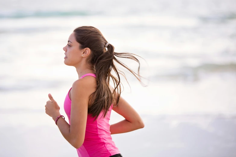 a woman running on a beach near the ocean, shutterstock, manuka, profile pic, sweat, girls