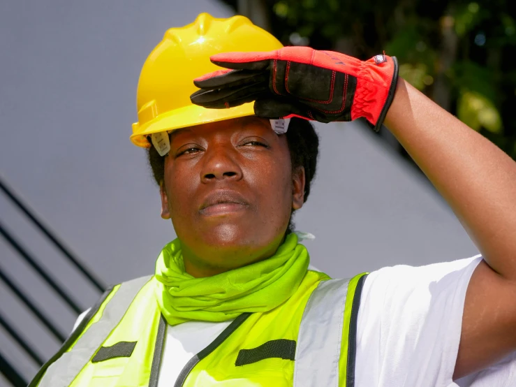 a woman wearing a hard hat and safety vest, a portrait, by Bernie D’Andrea, pexels, realism, his palms are sweaty, photo of a black woman, visor covering eyes, heatwave